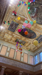 Luftballons fliegen an eine goldene Decke