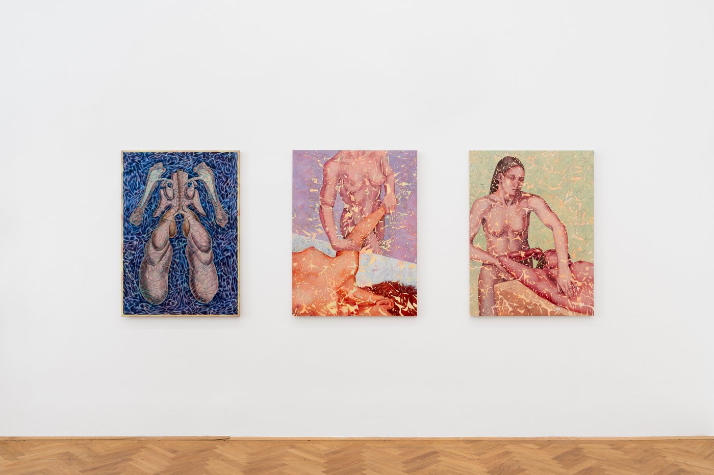 view of an exhibition room with three paintings on the wall