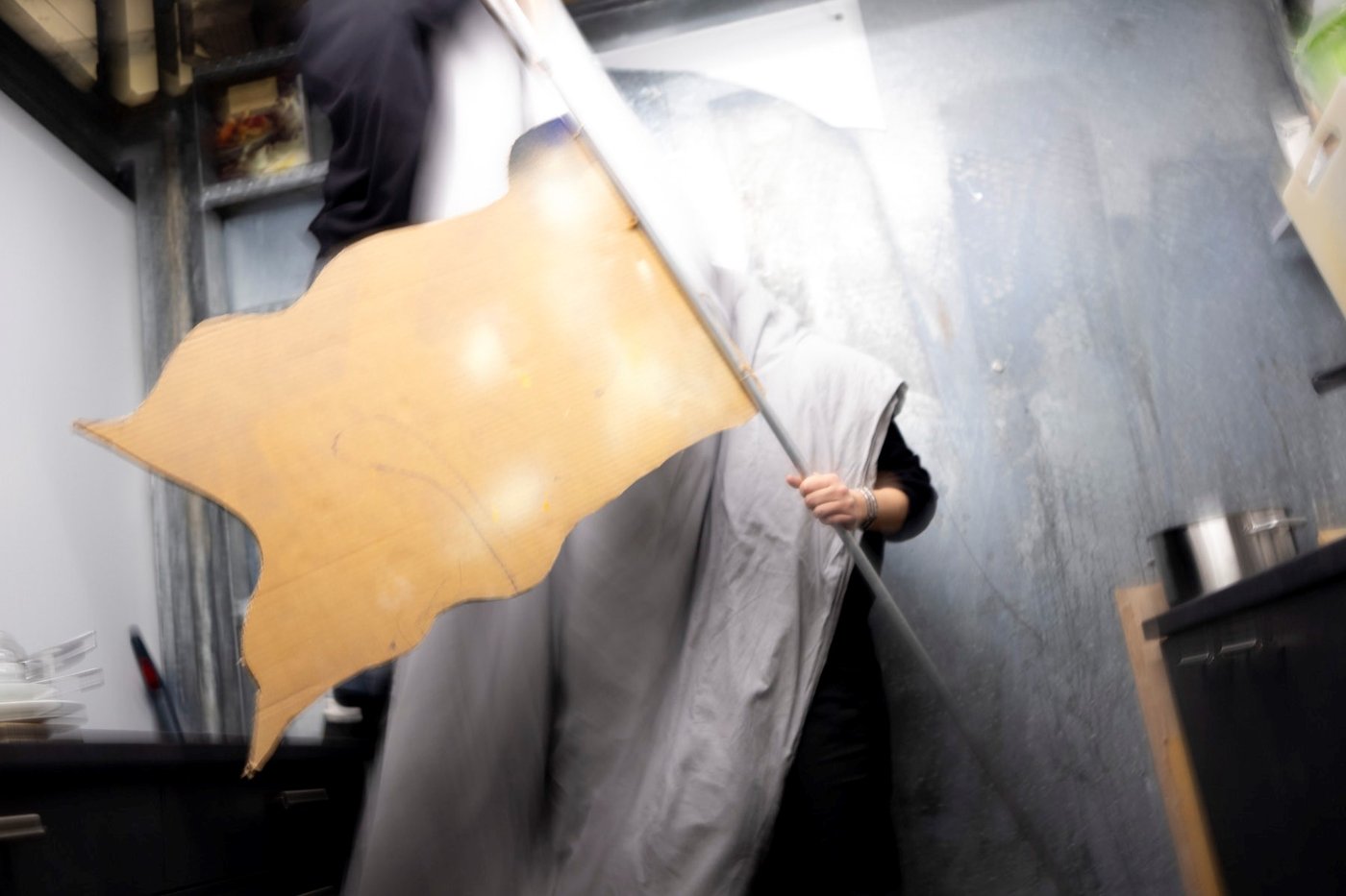 photo of a wooden flag helt by a person