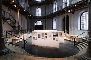 large room with artworks on white walls